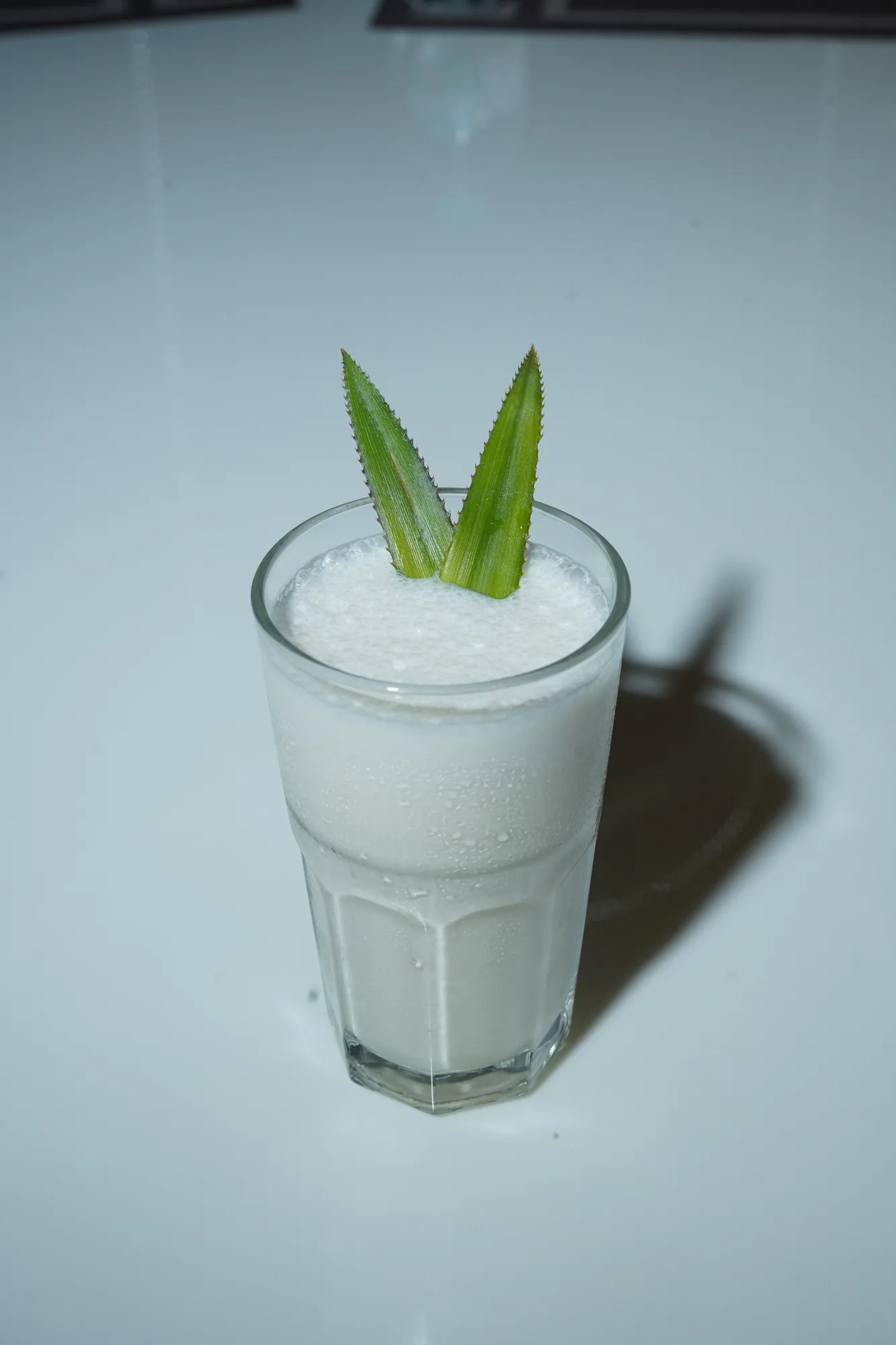 A chilled creamy lassi garnished with fresh leaves