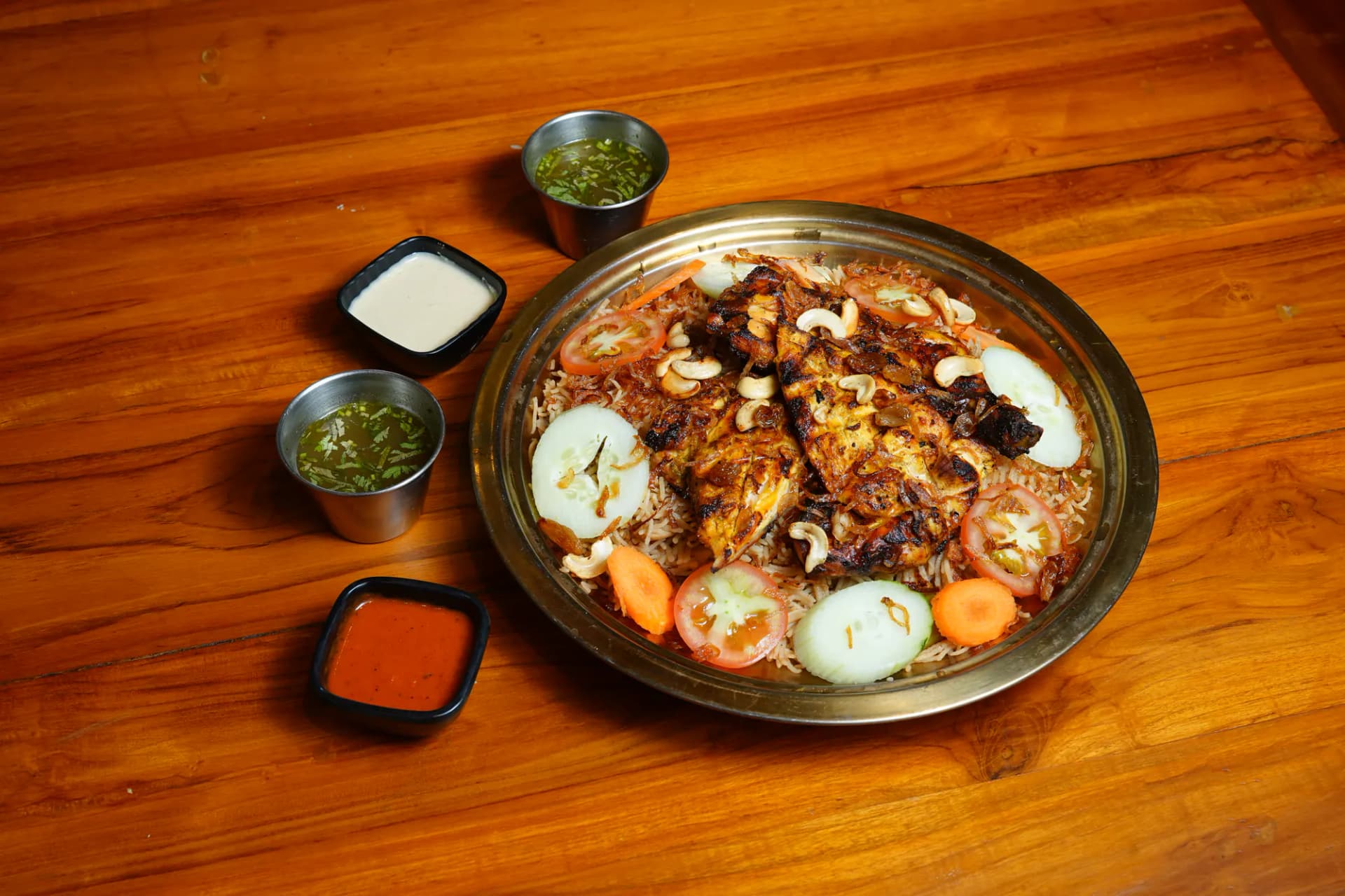 A generous platter of grilled chicken and fragrant rice with accompaniments
